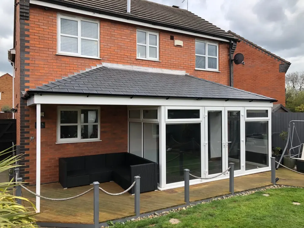 Hipped lean-to conservatory with a tiled roof fitted by Nu-Look