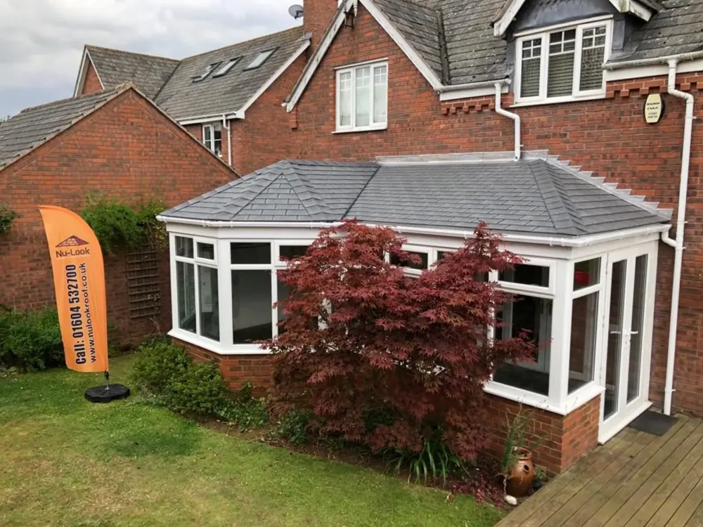 P Shape conservatory with a slate-effect tiled roof fitted by Nu-Look