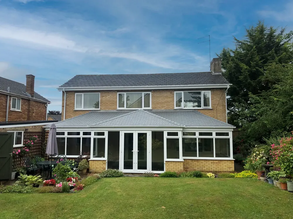 T-shape conservatory with a tiled roof fitted by Nu-Look